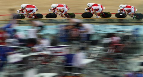 The Polish team, including Mateusz Nowak, Mateusz Nowaczek, Wojciech Pszczolarski and Mateusz Mikulicz compete in the Men's 3km Team Pursuit Qualifying race  during the European Track Cycling Championships in Panevezys, Lithuania, Friday, Oct. 19, 2012. (AP Photo/Mindaugas Kulbis)