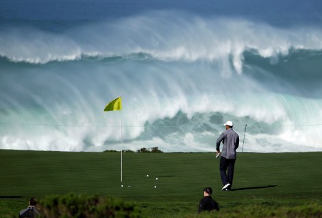 Tiger Woods walks to his ball on the 15th green of the Monterey Peninsula Country Club shore course as waves crash in the background during a practice round at the AT&T Pebble Beach National Pro-Am PGA Tour golf tournament in Pebble Beach, Calif., Wednesday, Feb. 8, 2012. (AP Photo/Eric Risberg)