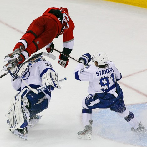 Carolina Hurricanes' Brandon Sutter (16) collides with Tampa Bay Lightning goalie Mathieu Garon (32) as Lightning's' Steven Stamkos (91) watches during the third period of an NHL hockey game in Raleigh, N.C., Saturday, March 3, 2012. Tampa Bay won 4-3 in overtime. (AP Photo/Karl B DeBlaker)
