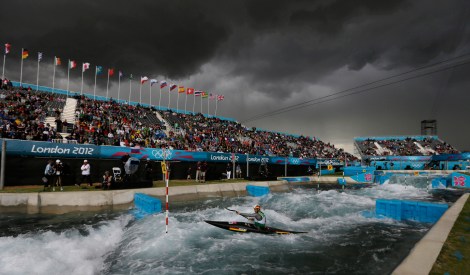 The sky turns black before a heavy rain shower as Germany's Hannes Aigner competes in the heats of the K-1 men's canoe slalom at Lee Valley Whitewater Center, at the 2012 Summer Olympics, Sunday, July 29, 2012, in London. (AP Photo/Kirsty Wigglesworth)