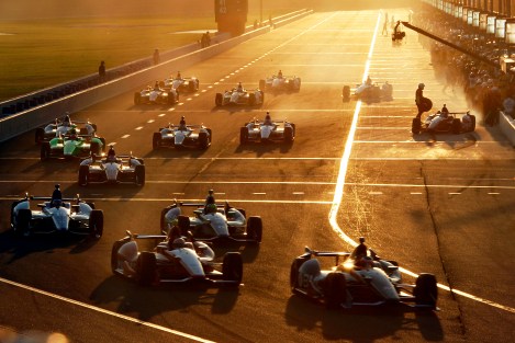 Cars pit during a caution flag in the IndyCar auto race at Auto Club Speedway in Fontana, Calif., Saturday, Sept. 15, 2012. (AP Photo/Reed Saxon)